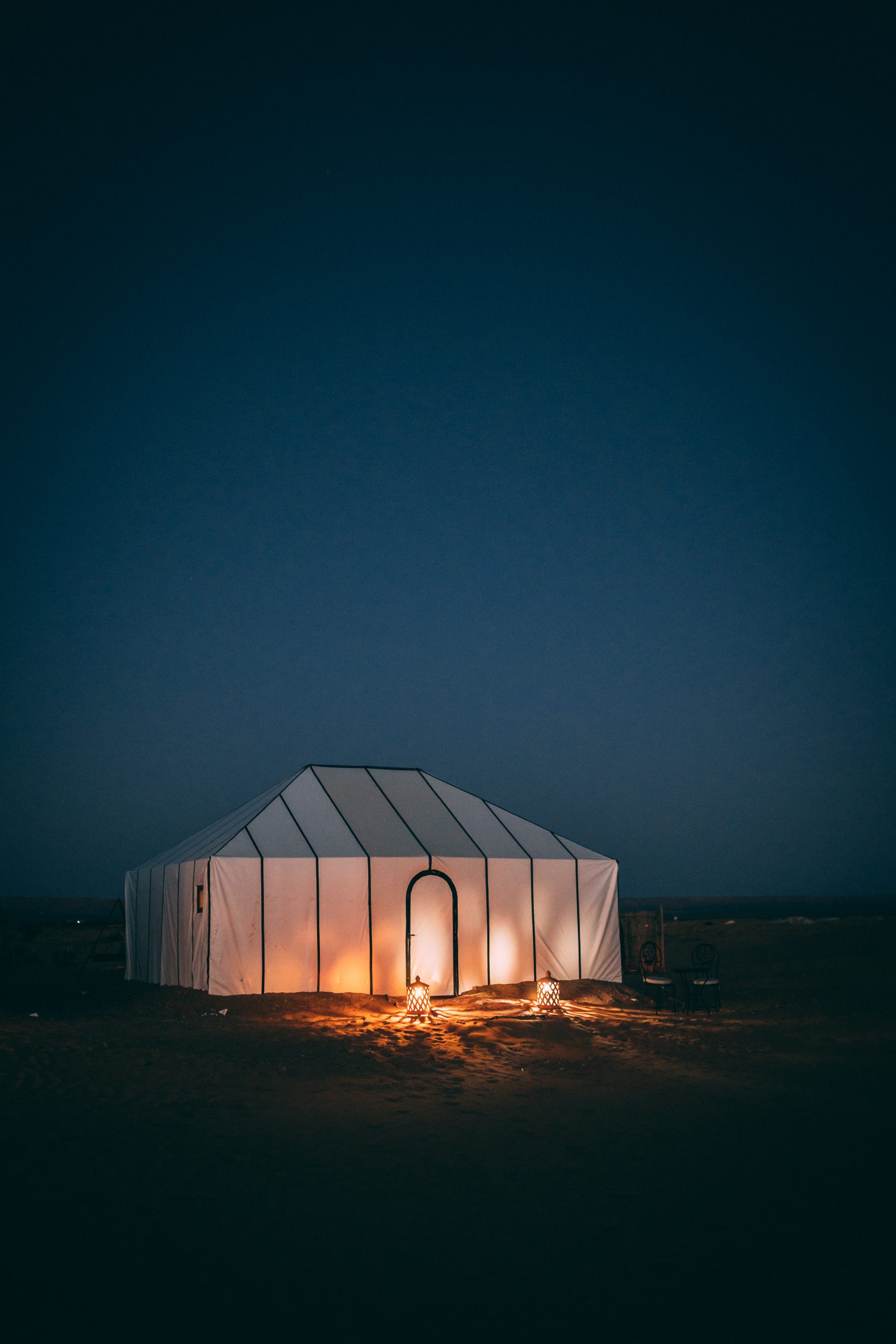 white tent on brown sand during night time